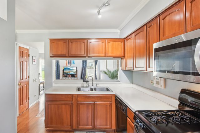 3407 Sandpiper Drive Aurora, IL 60504 - Photo 9 of 20 a kitchen with stainless steel appliances granite countertop a sink stove and cabinets