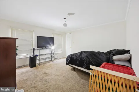 a bedroom with furniture and a flat screen tv