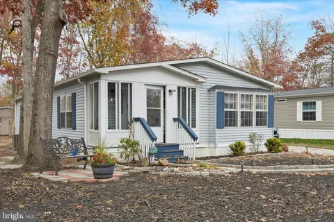 a front view of a house with sitting area
