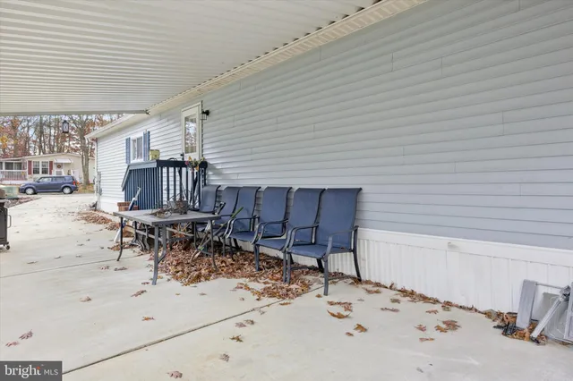 a view of a terrace with a table and chairs