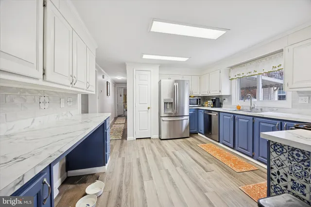 a kitchen with stainless steel appliances granite countertop a refrigerator sink and cabinets