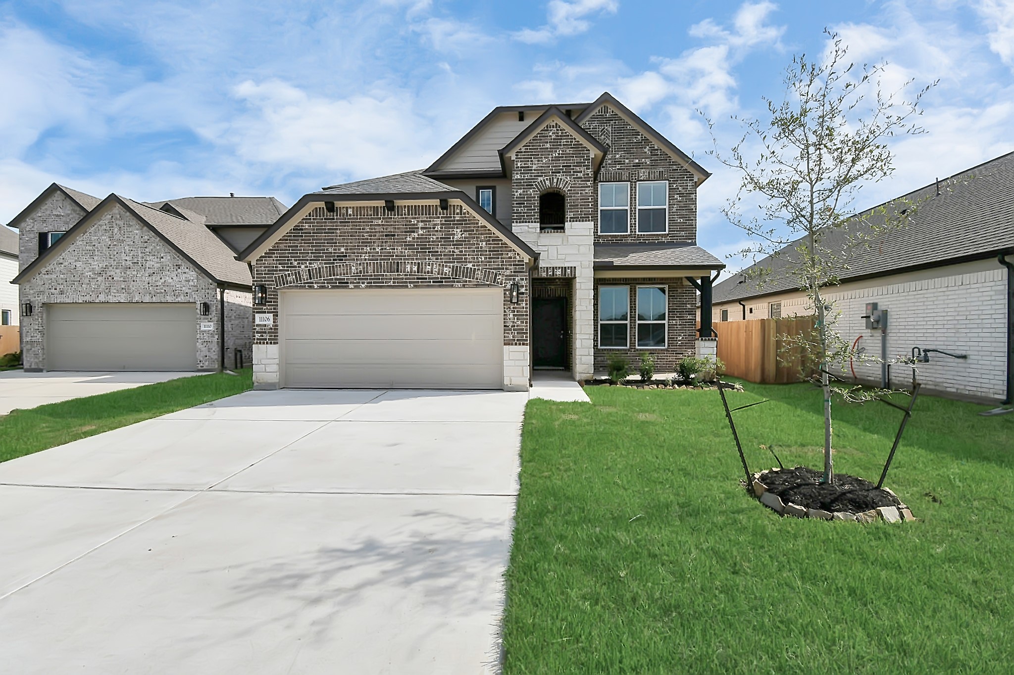 11106 Crocus Drive Houston, TX 77044 - Photo 2 of 40 a front view of a house with a yard and a garage