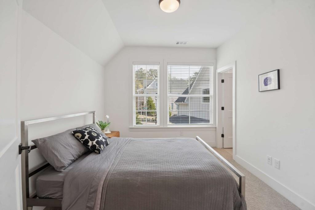 1105 Adam Circle Roswell, GA 30076 - Photo 24 of 34 a bed sitting in a bedroom next to a window