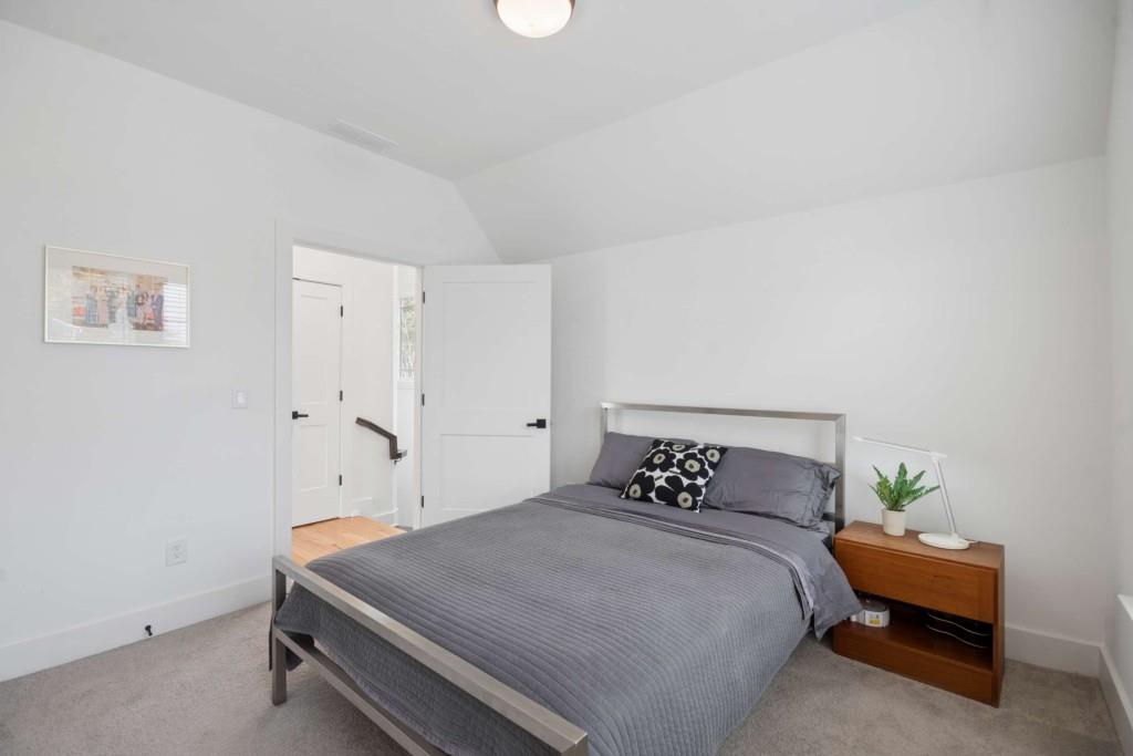 1105 Adam Circle Roswell, GA 30076 - Photo 25 of 34 a bedroom with a bed and a potted plant