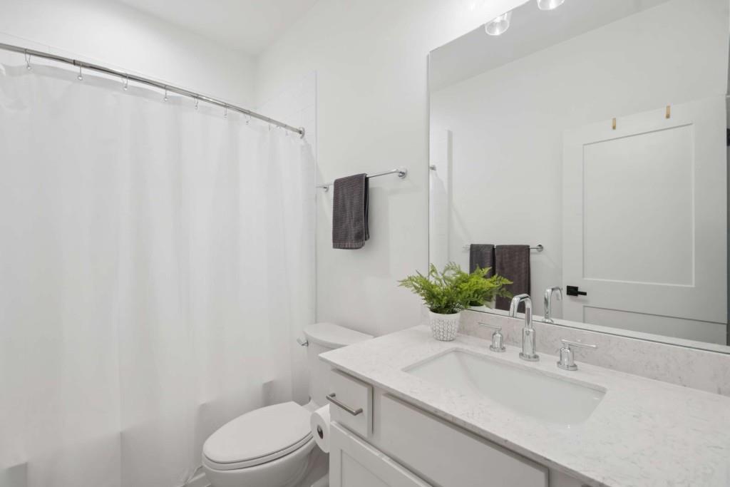 1105 Adam Circle Roswell, GA 30076 - Photo 32 of 34 a bathroom with a sink toilet and mirror