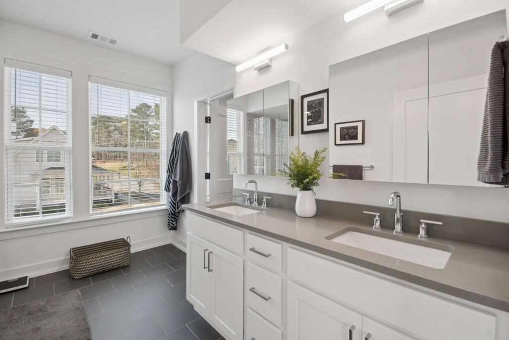 1105 Adam Circle Roswell, GA 30076 - Photo 5 of 34 a bathroom with a granite countertop sink and a large mirror