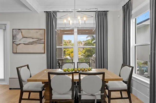 a living room with furniture kitchen view and a large mirror
