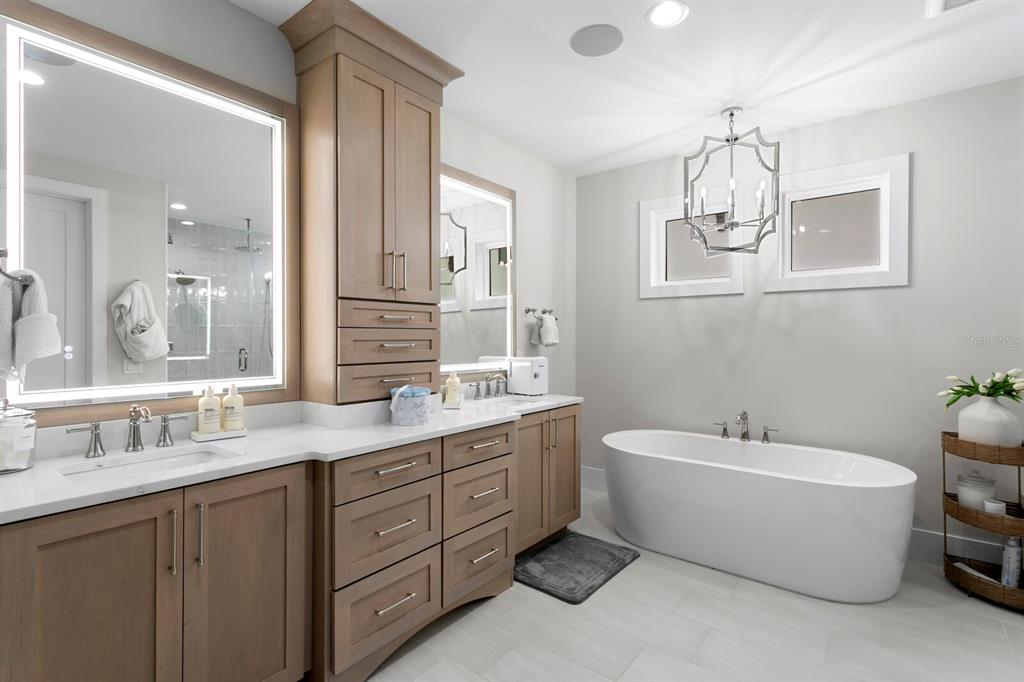 4807 West San Rafael Street Tampa, FL 33629 - Photo 25 of 64 a spacious bathroom with a double vanity sink a mirror and a bathtub