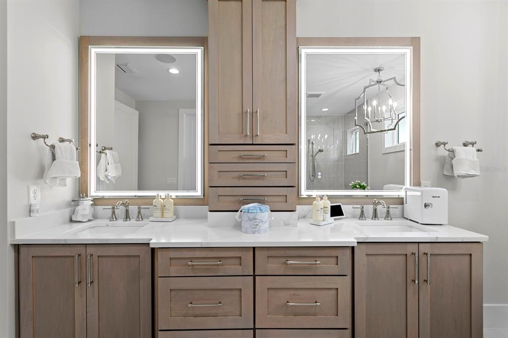 4807 West San Rafael Street Tampa, FL 33629 - Photo 26 of 64 a bathroom with double vanity sinks and a mirror