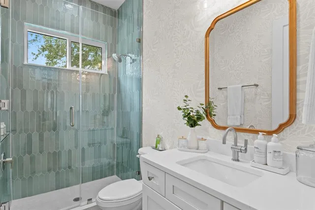 a bedroom with a bed tv and couch