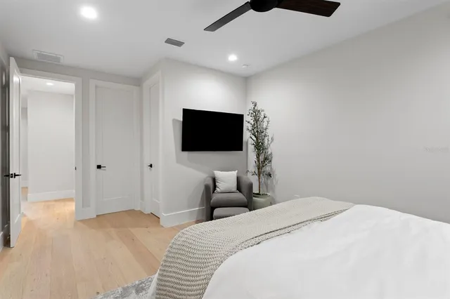 a bedroom with a bed and a flat screen tv