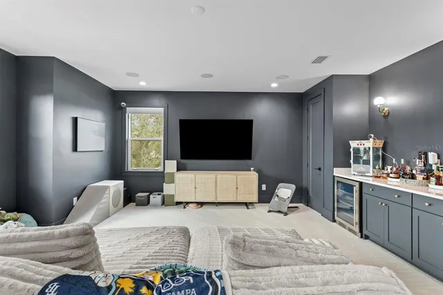 a bedroom with a bed couch and window