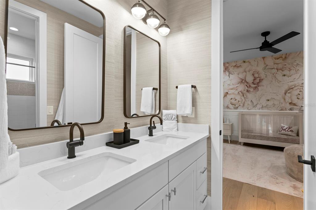 4807 West San Rafael Street Tampa, FL 33629 - Photo 40 of 64 a bathroom with double vanity sinks a mirror and a shower