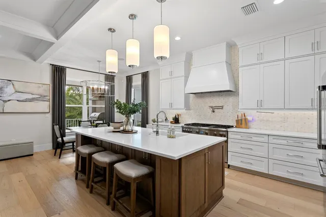 a kitchen with stainless steel appliances granite countertop a sink and a refrigerator