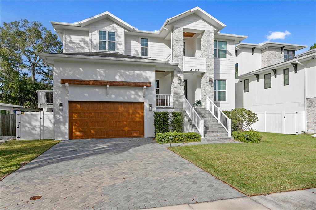 4807 West San Rafael Street Tampa, FL 33629 - Photo 63 of 64 a front view of a house with a yard and garage