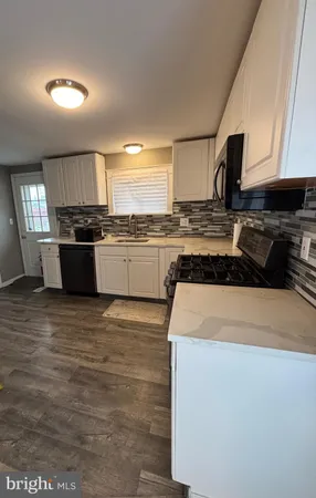 a kitchen with kitchen island granite countertop wooden cabinets and a stove