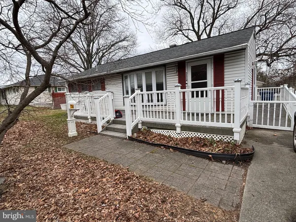 a view of a house with a yard and wooden fence