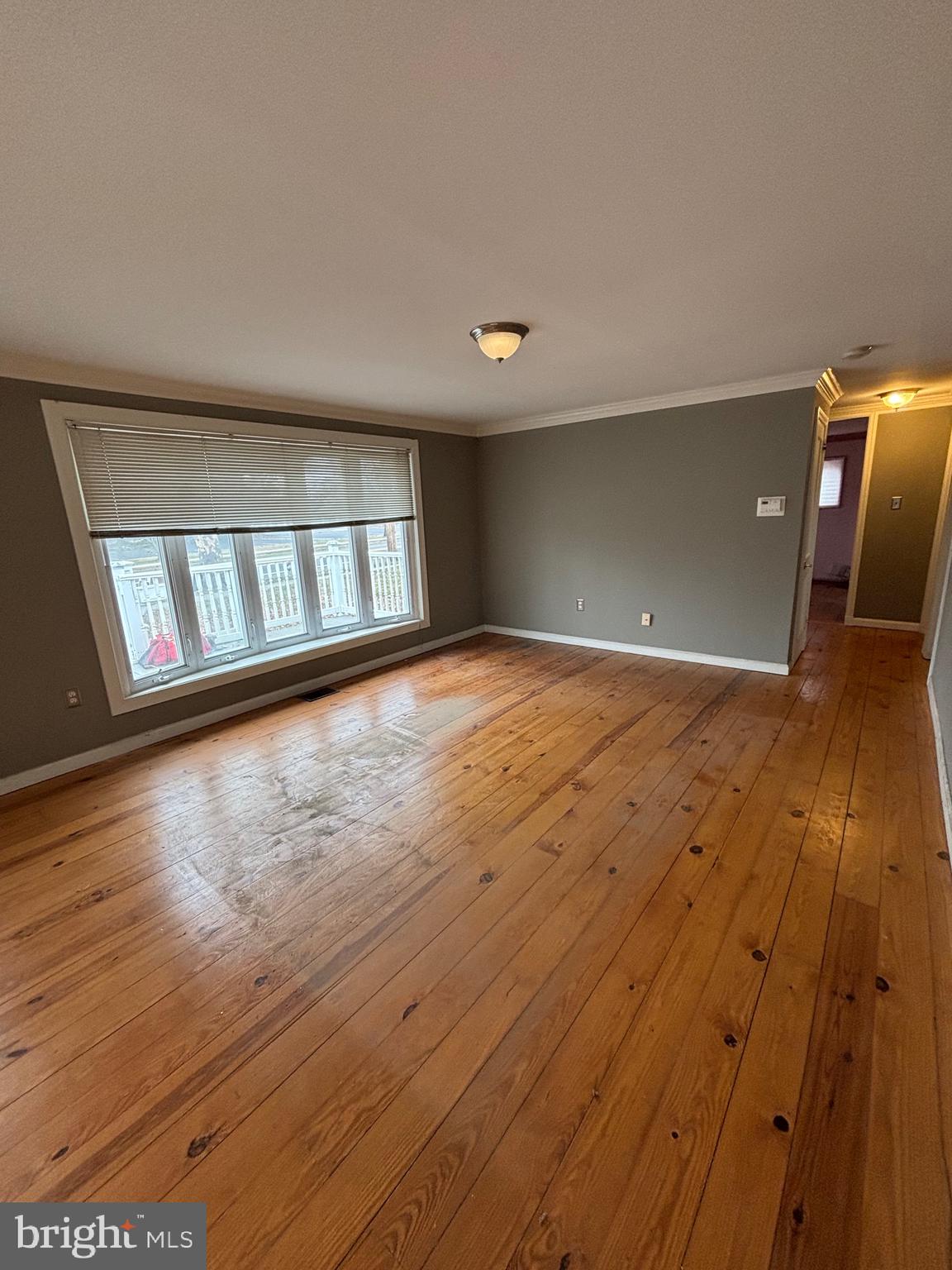 734 Main Street Lumberton, NJ 08048 - Photo 9 of 13 wooden floor in an empty room with a window