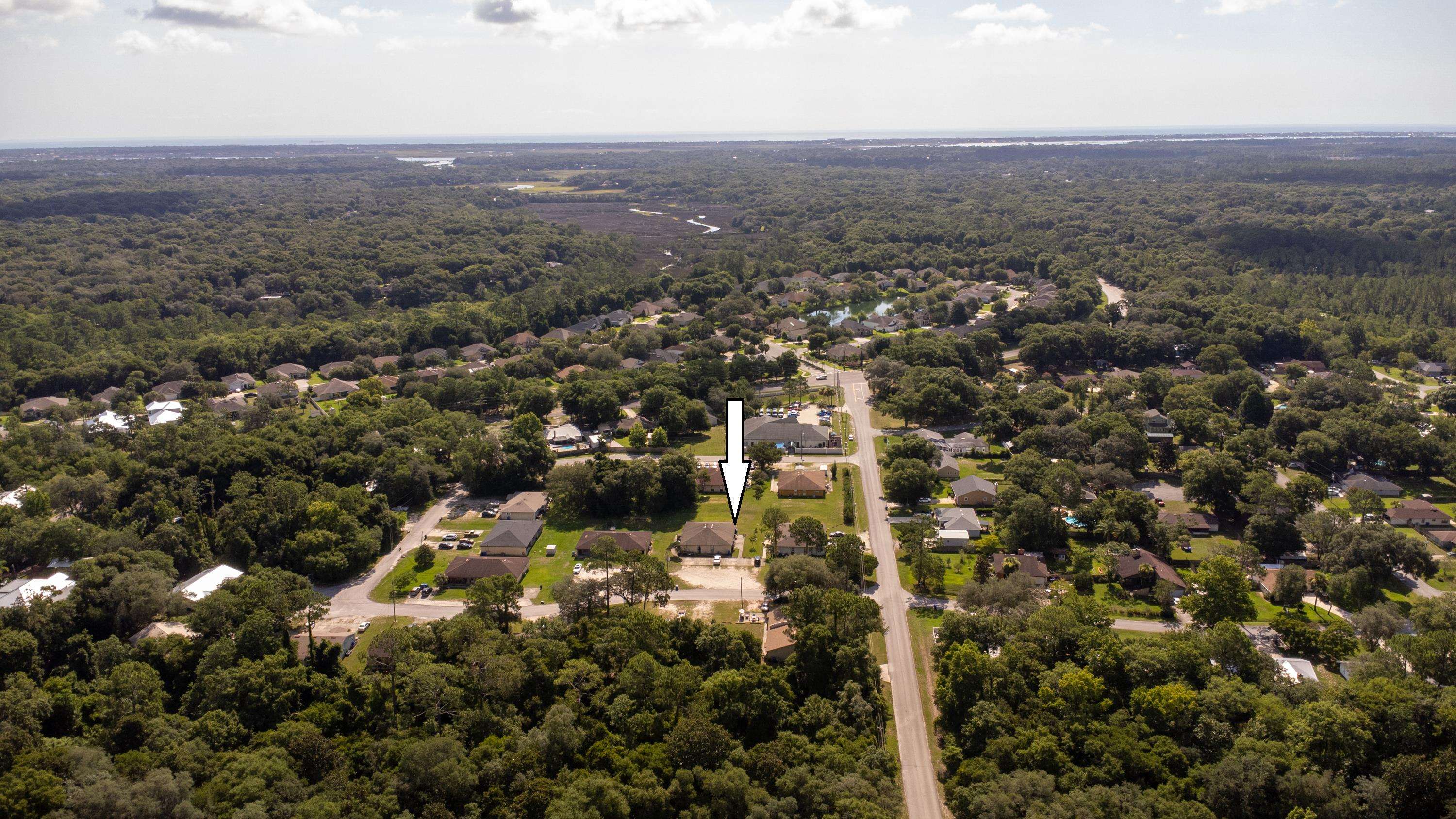 3885 Osprey Circle, Unit D St. Augustine, FL 32086 - Photo 1 of 12 an aerial view of house with yard and mountain view in back