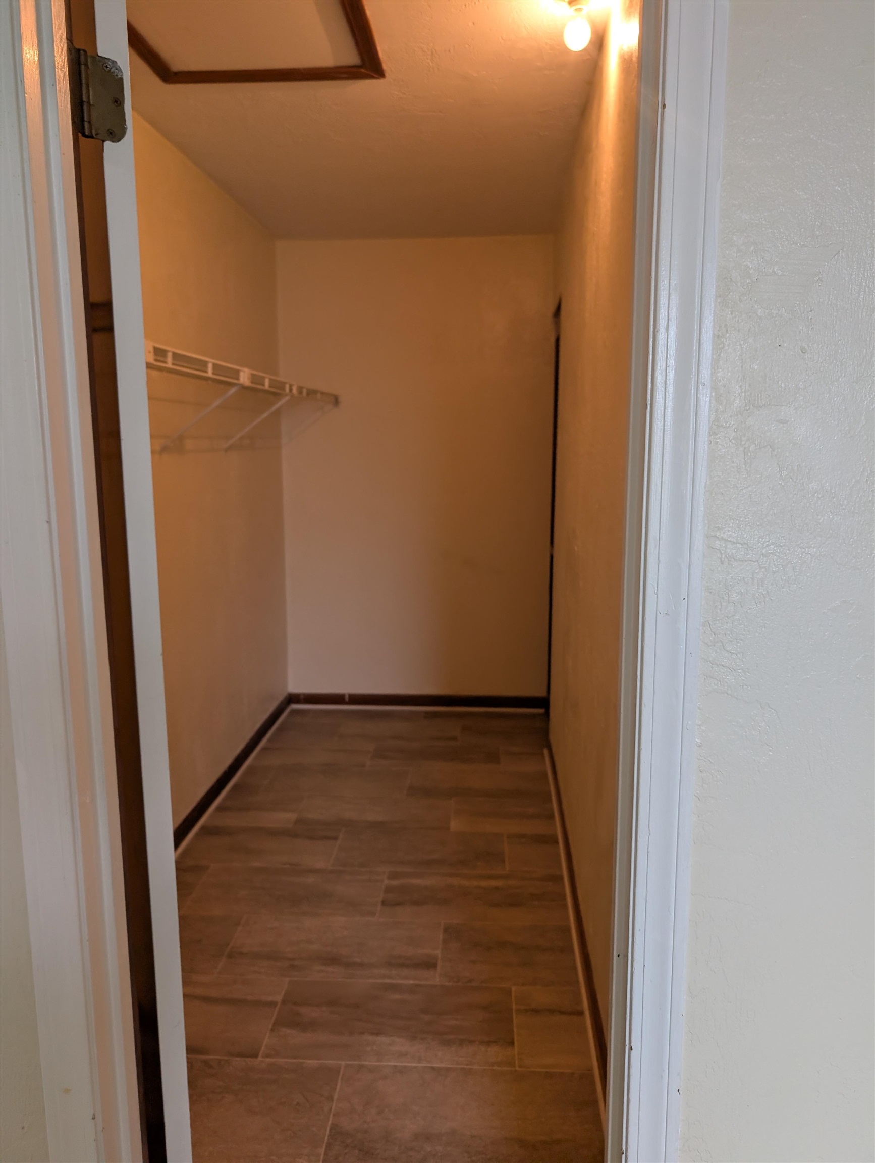 3885 Osprey Circle, Unit D St. Augustine, FL 32086 - Photo 3 of 12 Spacious closet featuring elevator and dark wood finished floors