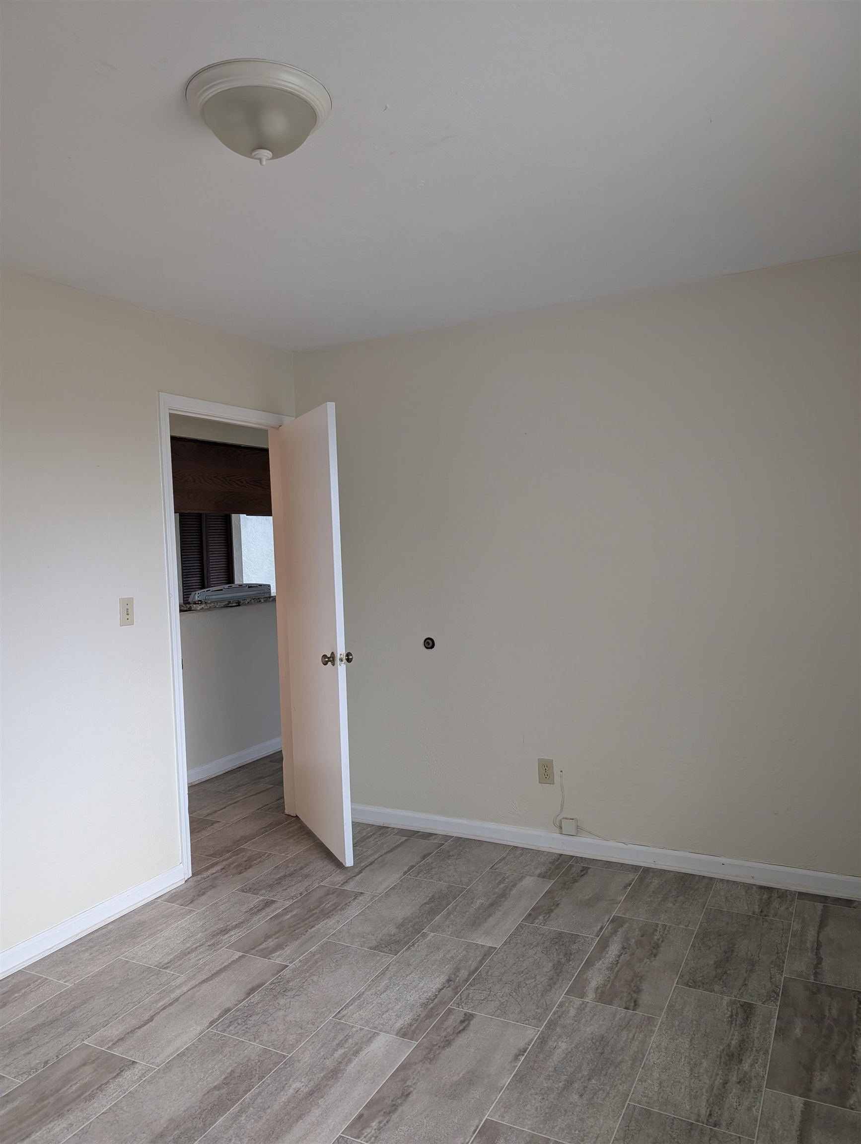 3885 Osprey Circle, Unit D St. Augustine, FL 32086 - Photo 4 of 12 Unfurnished room featuring wood tiled floors
