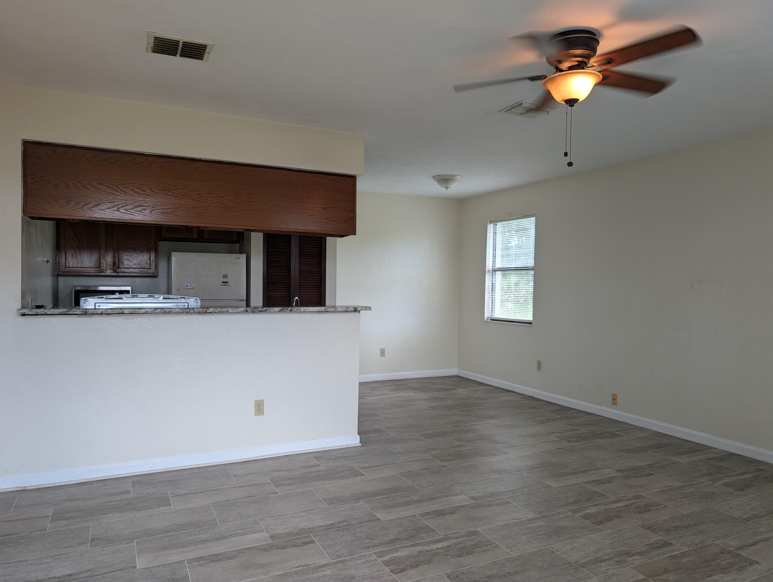 3885 Osprey Circle, Unit D St. Augustine, FL 32086 - Photo 7 of 12 Unfurnished living room featuring ceiling fan and wood tiled floors