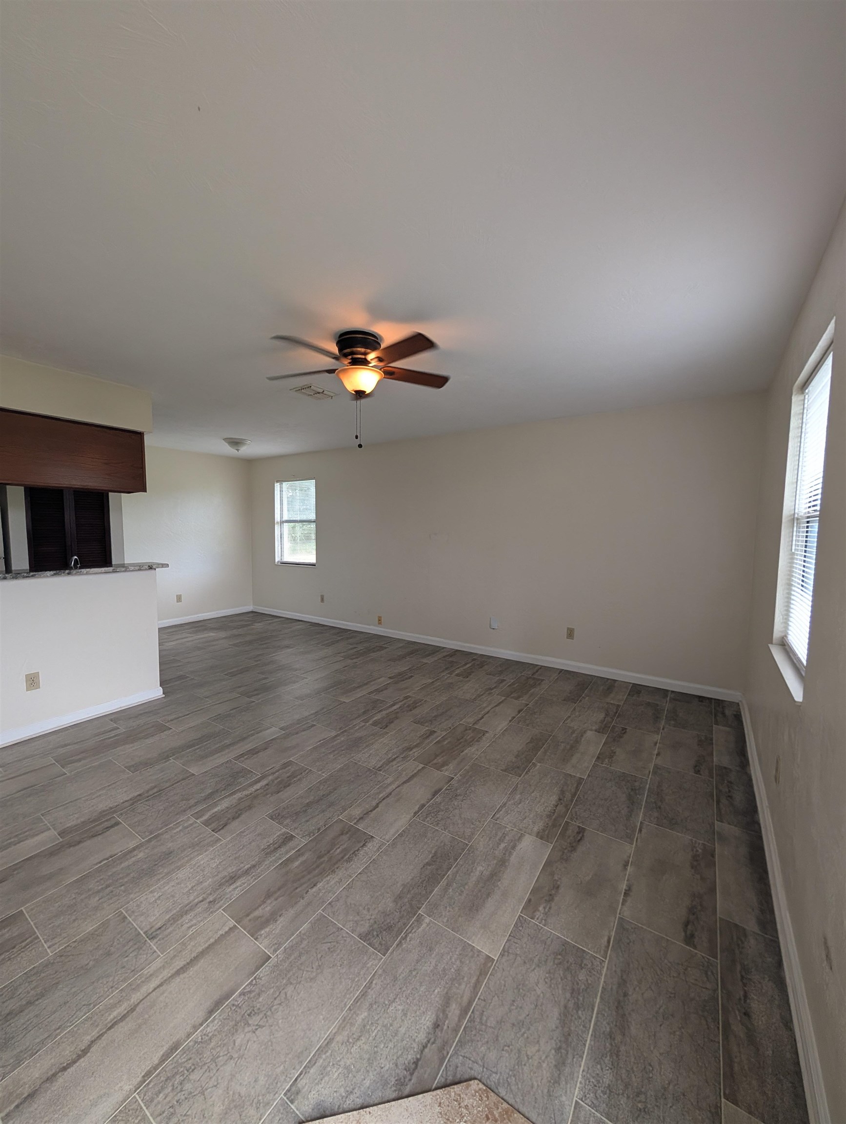 3885 Osprey Circle, Unit D St. Augustine, FL 32086 - Photo 8 of 12 Unfurnished living room with ceiling fan and wood finish floors