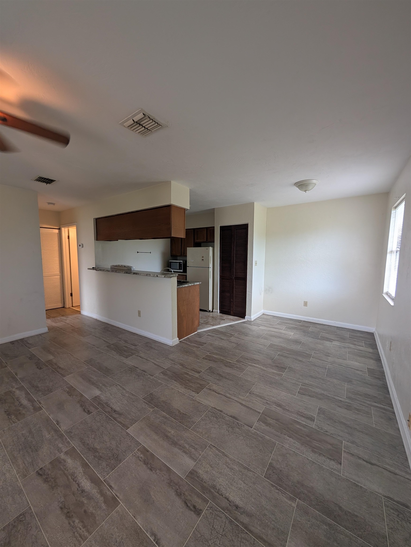 3885 Osprey Circle, Unit D St. Augustine, FL 32086 - Photo 9 of 12 Unfurnished living room with baseboards and a ceiling fan