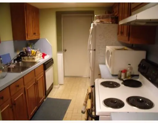 a kitchen with a sink a stove and cabinets