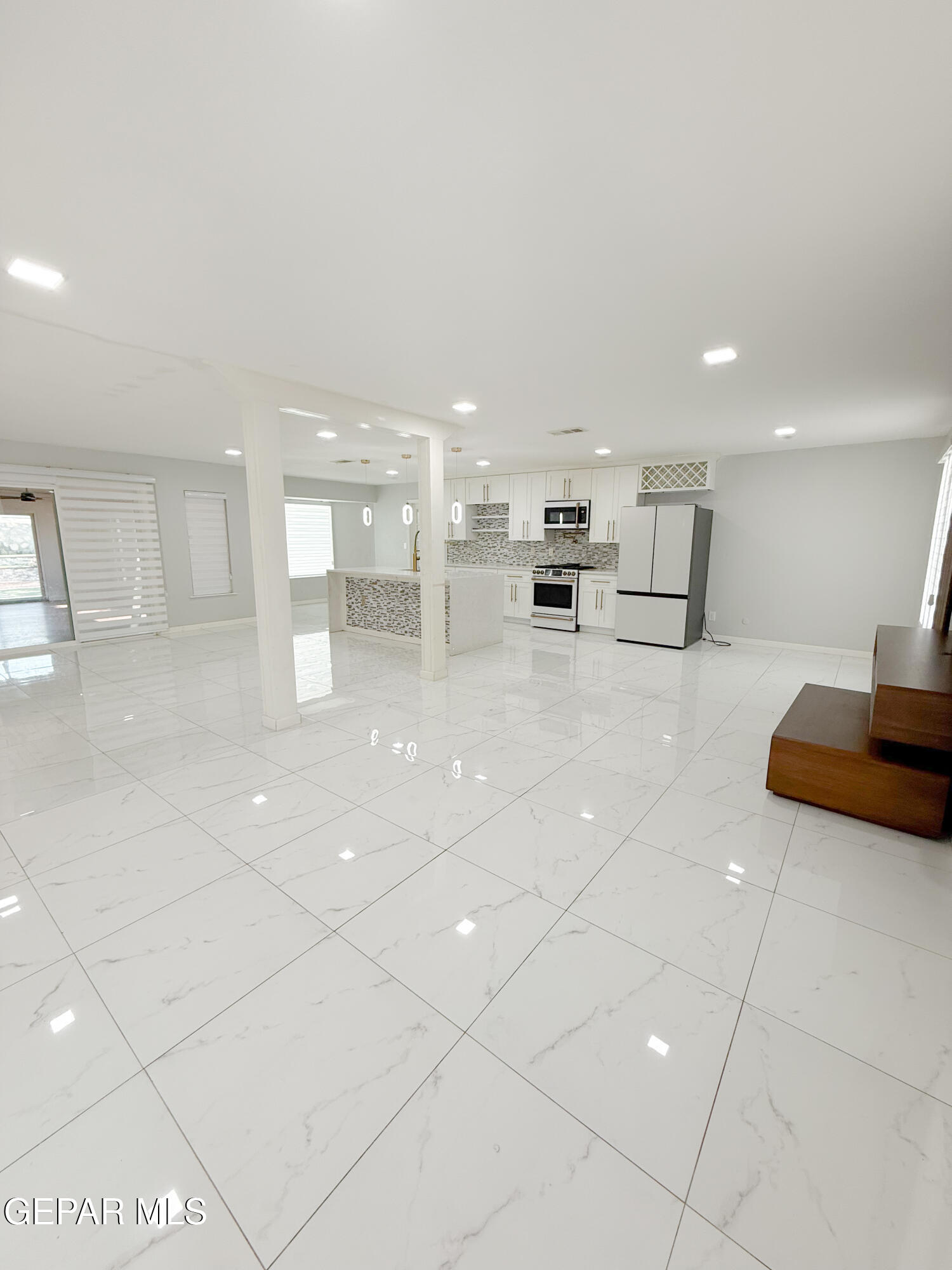 3112 Eads Place El Paso, TX 79935 - Photo 4 of 24 a large white kitchen with lots of counter space cabinets and a couch