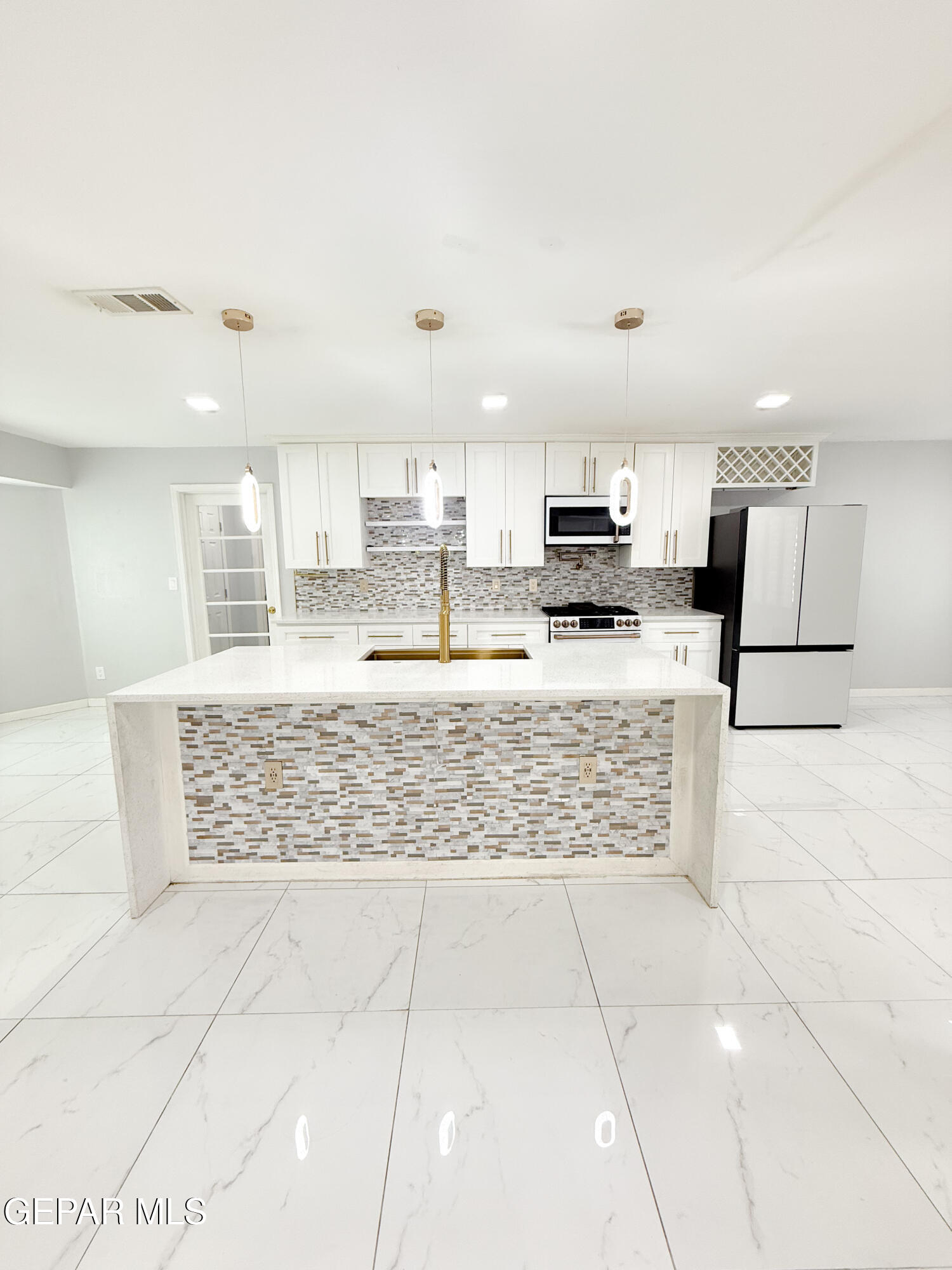 3112 Eads Place El Paso, TX 79935 - Photo 5 of 24 a kitchen with stainless steel appliances kitchen island granite countertop a stove a sink and a refrigerator