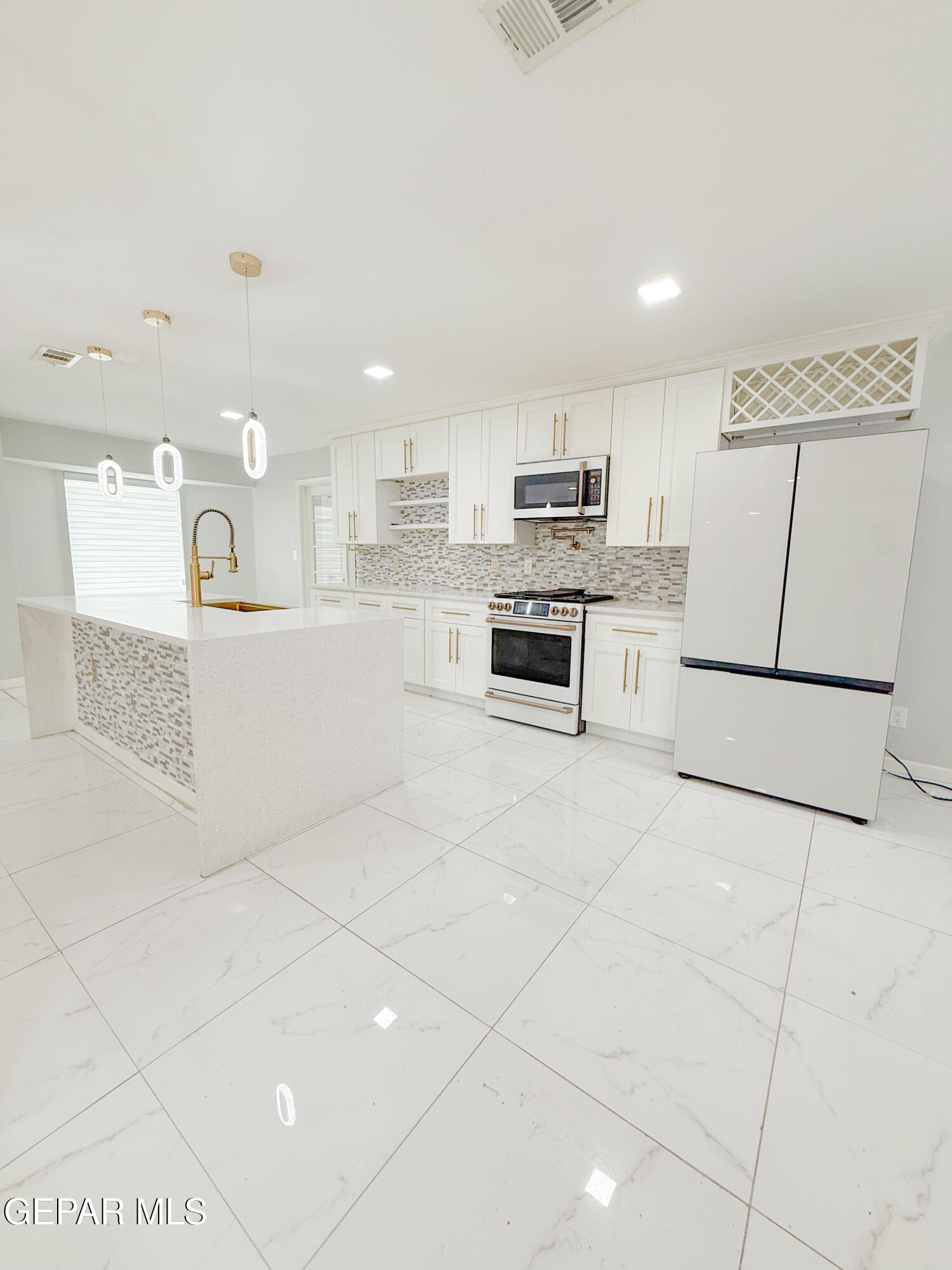 3112 Eads Place El Paso, TX 79935 - Photo 6 of 24 a large white kitchen with a sink and cabinets