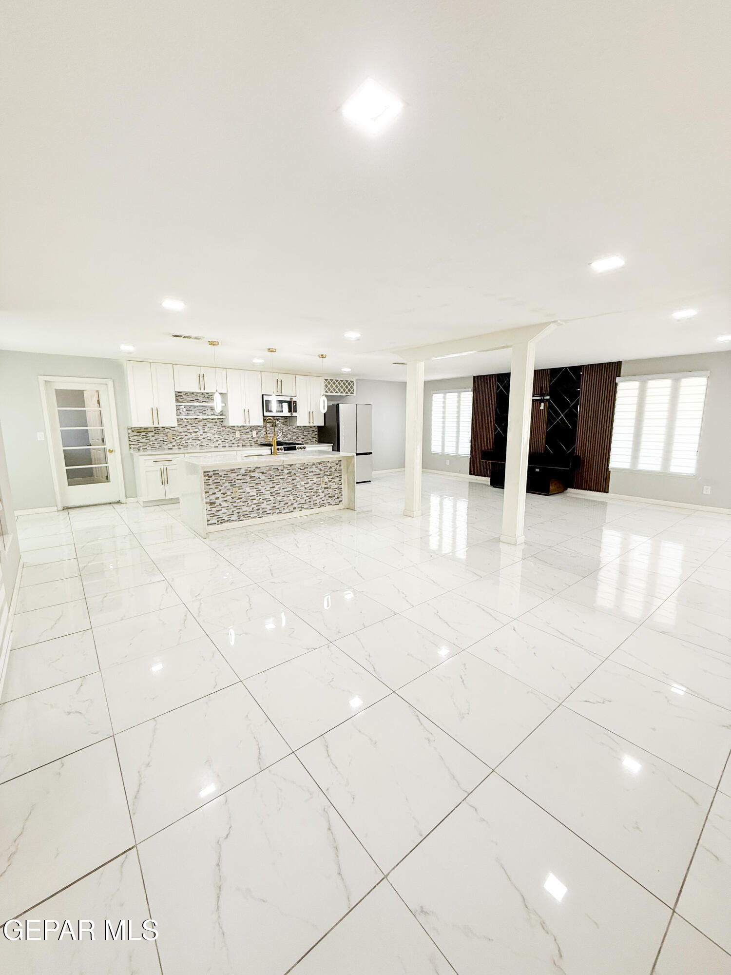 3112 Eads Place El Paso, TX 79935 - Photo 8 of 24 a kitchen with stainless steel appliances kitchen island granite countertop a refrigerator and a stove top oven