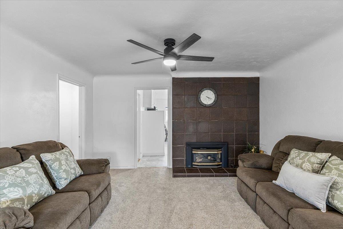 232 Fusco Avenue Modesto, CA 95354 - Photo 12 of 52 a living room with furniture and a fireplace