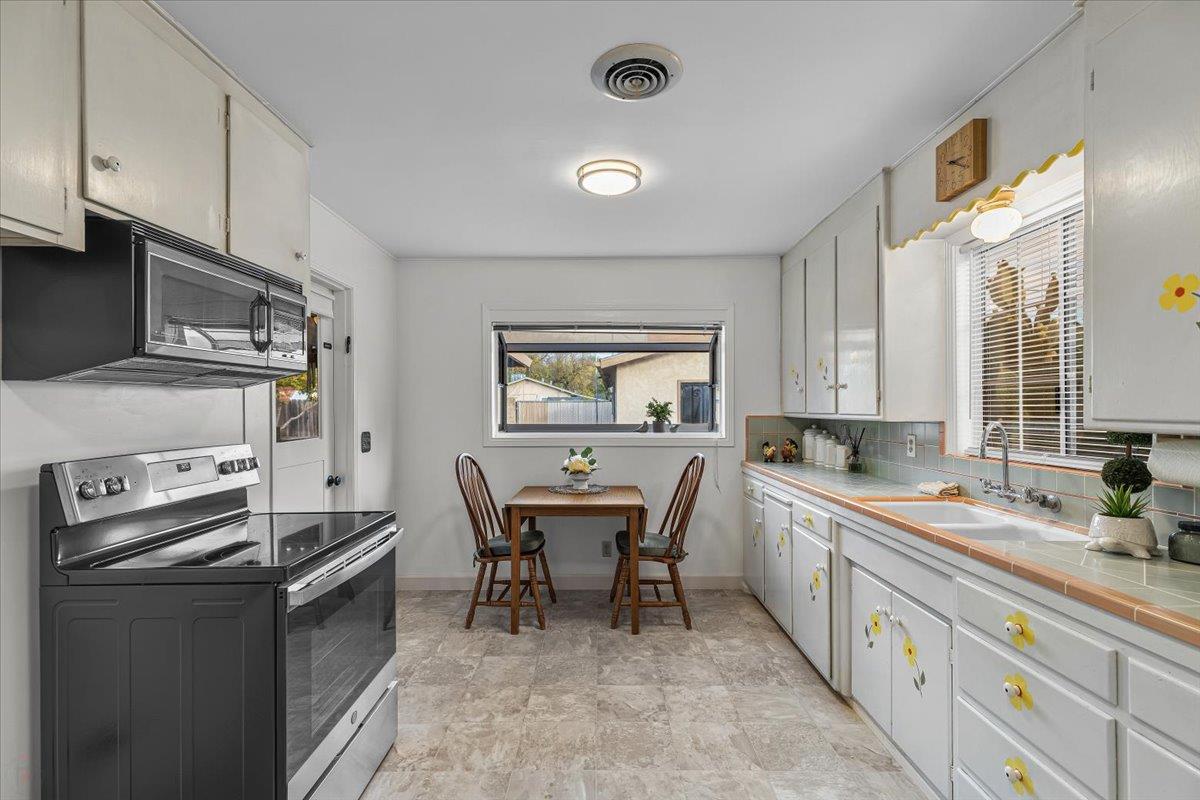 232 Fusco Avenue Modesto, CA 95354 - Photo 14 of 52 a kitchen with a sink stove and cabinets