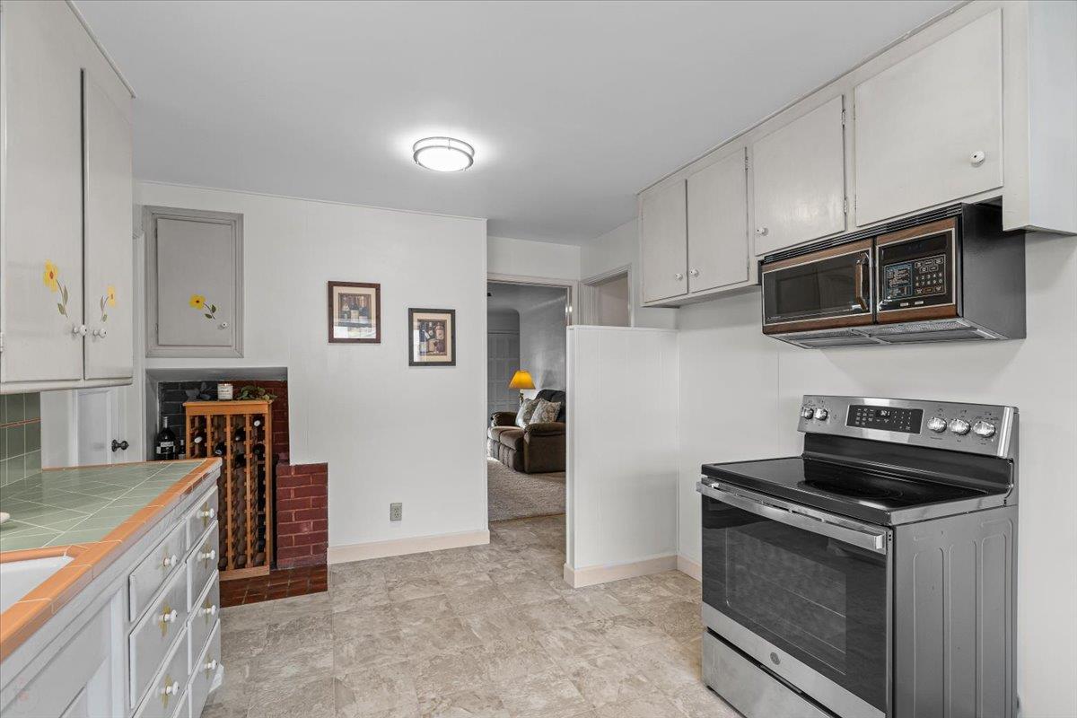 232 Fusco Avenue Modesto, CA 95354 - Photo 17 of 52 a kitchen with stainless steel appliances a stove a microwave and a refrigerator