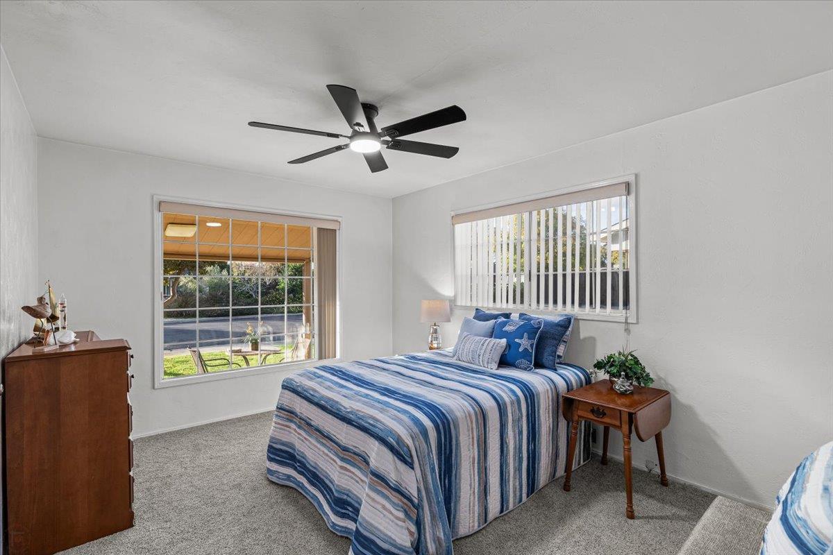 232 Fusco Avenue Modesto, CA 95354 - Photo 24 of 52 a bedroom with a bed and a chandelier