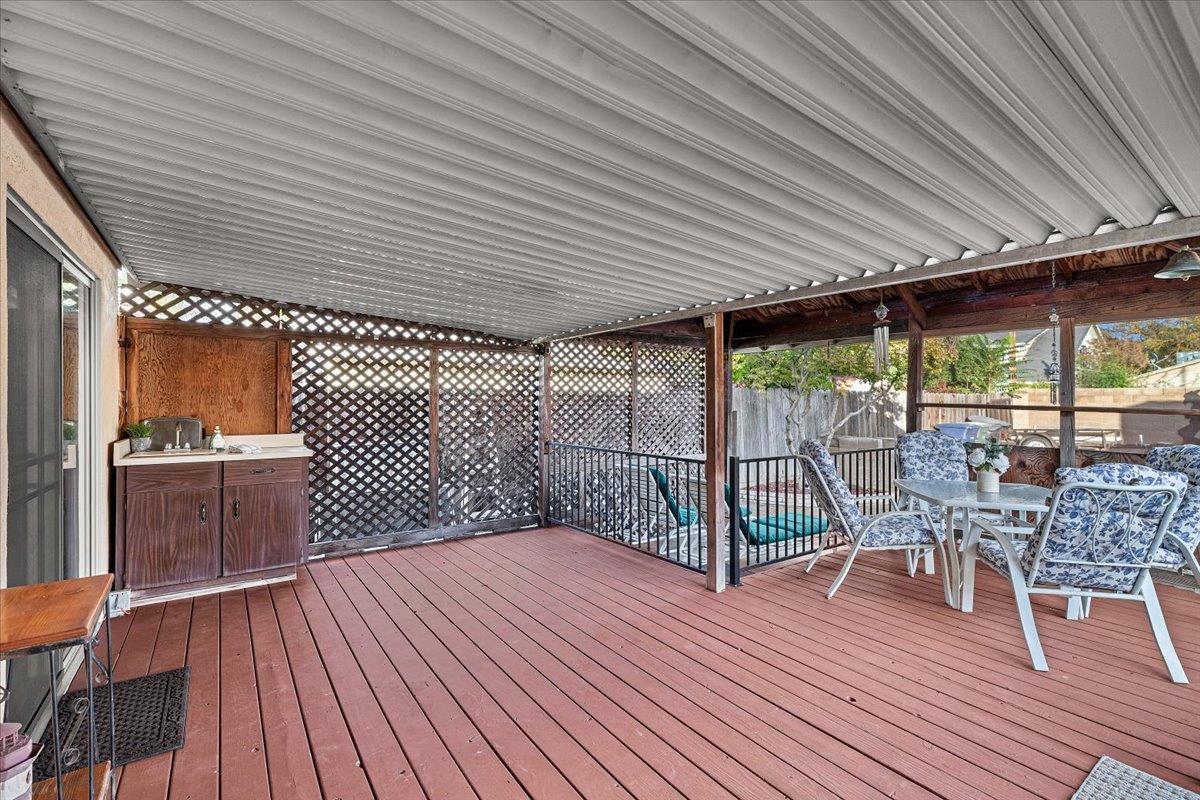 232 Fusco Avenue Modesto, CA 95354 - Photo 28 of 52 a roof deck with table and chairs and wooden floor