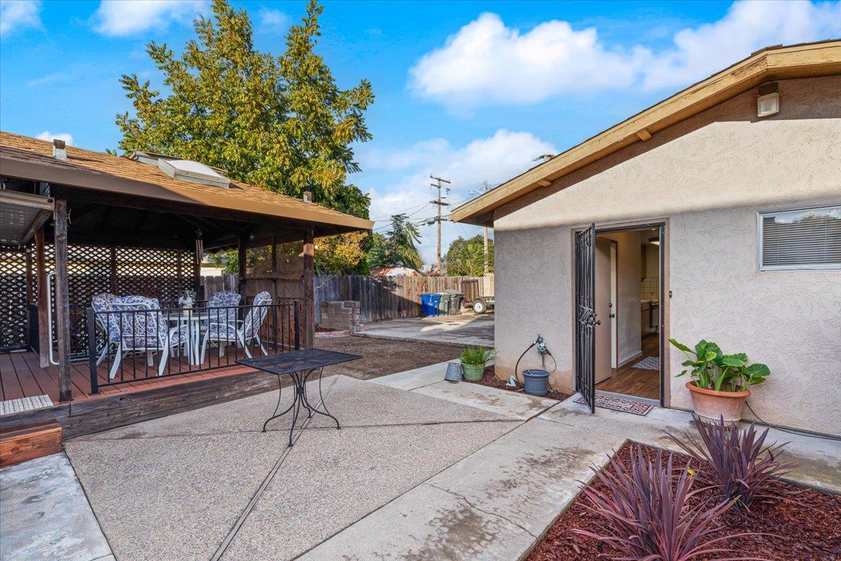 232 Fusco Avenue Modesto, CA 95354 - Photo 34 of 52 a patio with a table and chairs and potted plants