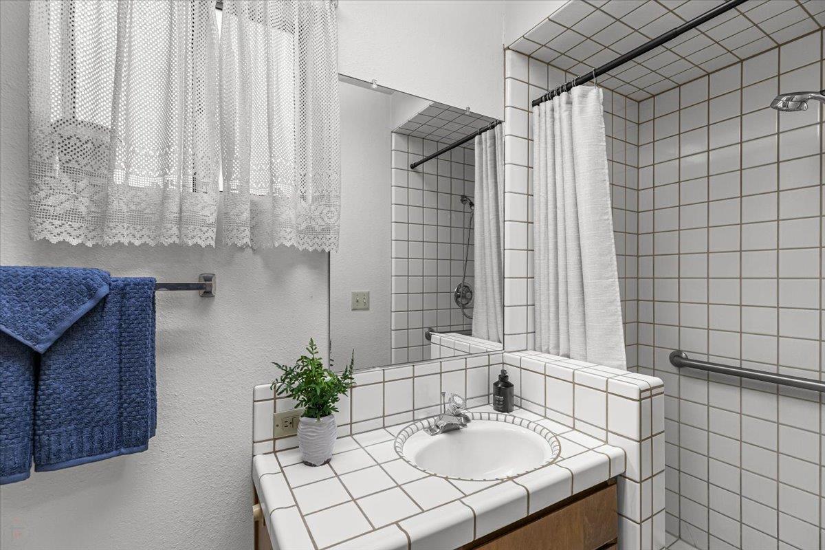 232 Fusco Avenue Modesto, CA 95354 - Photo 39 of 52 a bathroom with a sink and a mirror