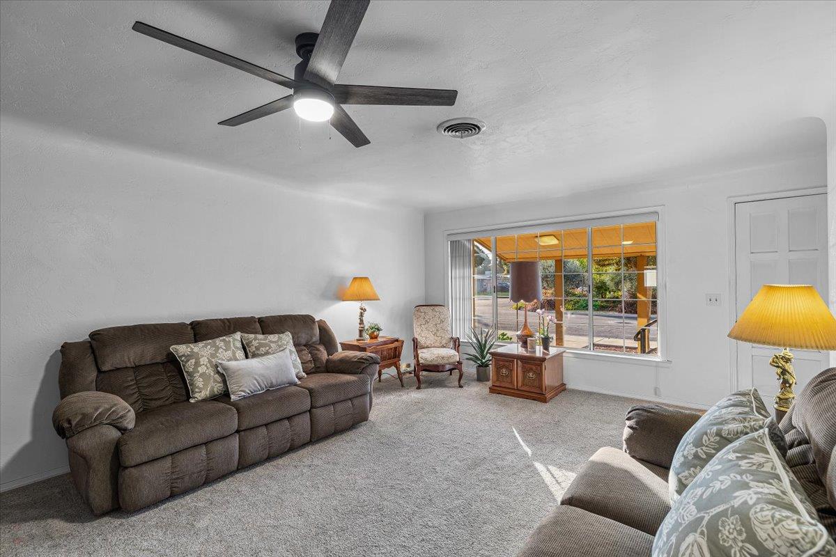 232 Fusco Avenue Modesto, CA 95354 - Photo 8 of 52 a living room with furniture and a large window with garden view