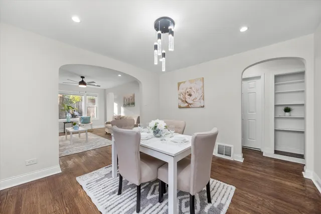 a view of a dining room with furniture wooden floor and chandelier