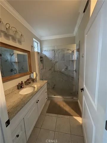 a kitchen with granite countertop a sink a stove a microwave and cabinets