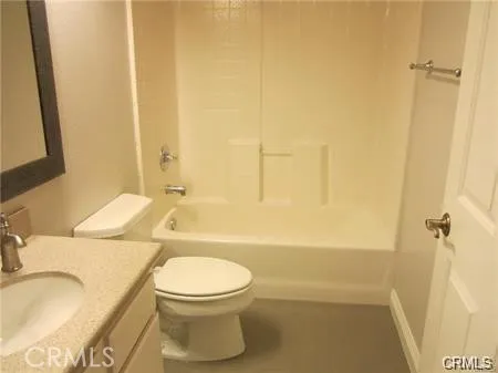 a kitchen with granite countertop a refrigerator and a sink