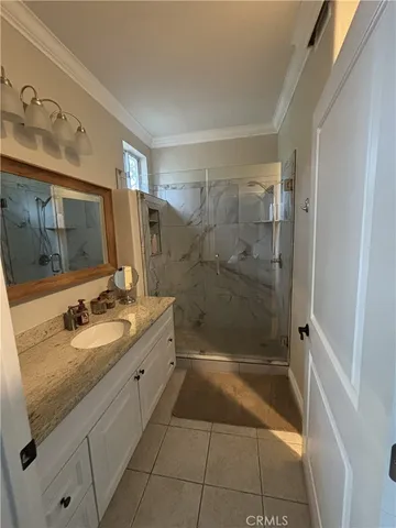 a bathroom with a granite countertop bathtub sink vanity mirror and toilet