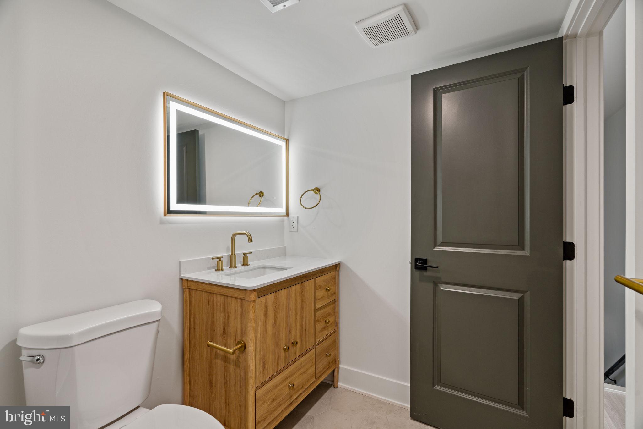 2410 Nicholas Street Philadelphia, PA 19121 - Photo 19 of 55 a bathroom with a sink toilet and mirror