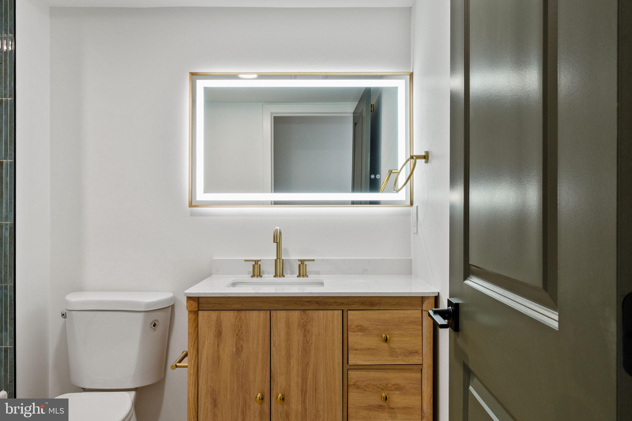 2410 Nicholas Street Philadelphia, PA 19121 - Photo 21 of 55 a bathroom with a sink and mirror