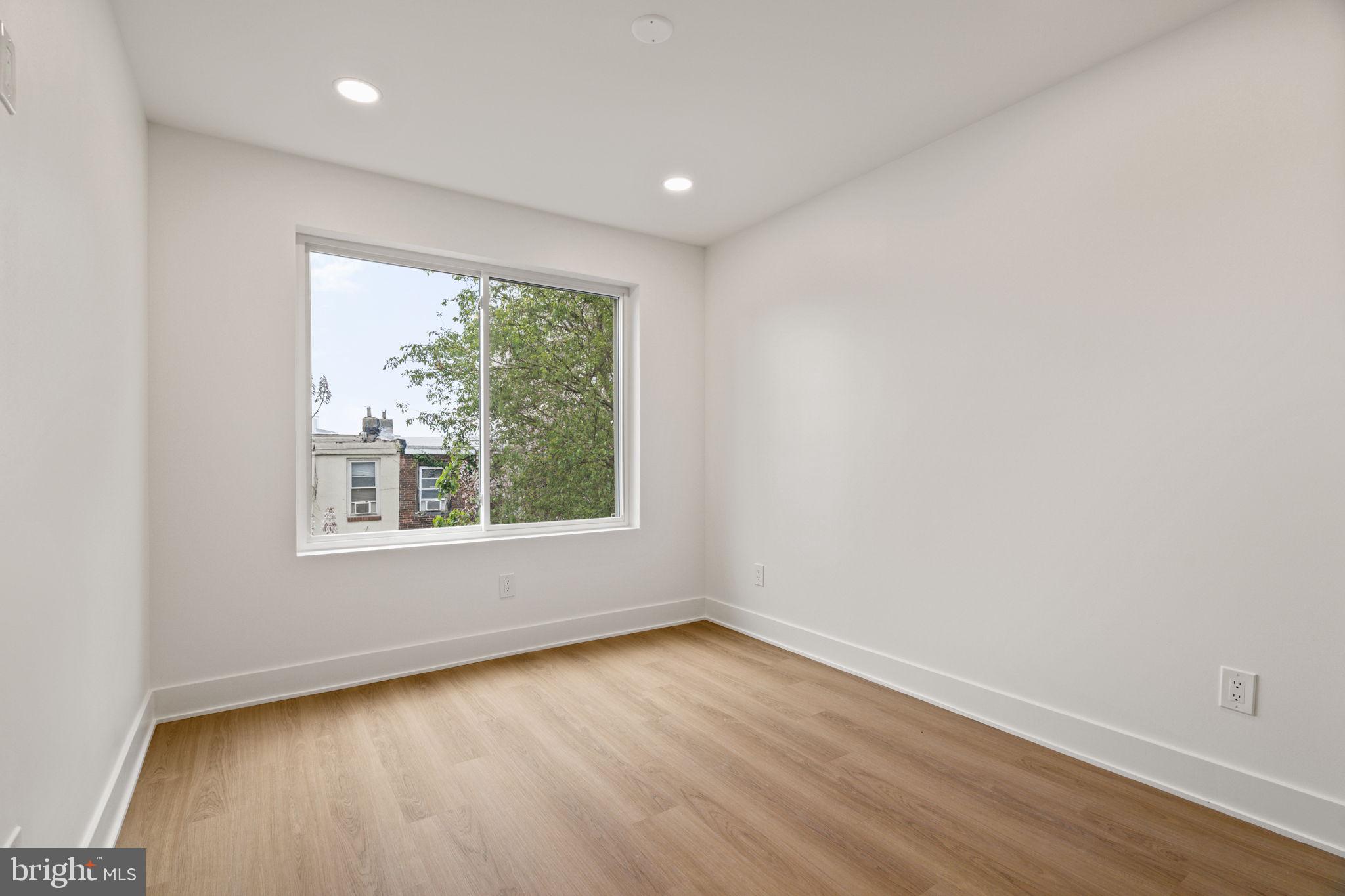 2410 Nicholas Street Philadelphia, PA 19121 - Photo 22 of 55 an empty room with wooden floor and windows