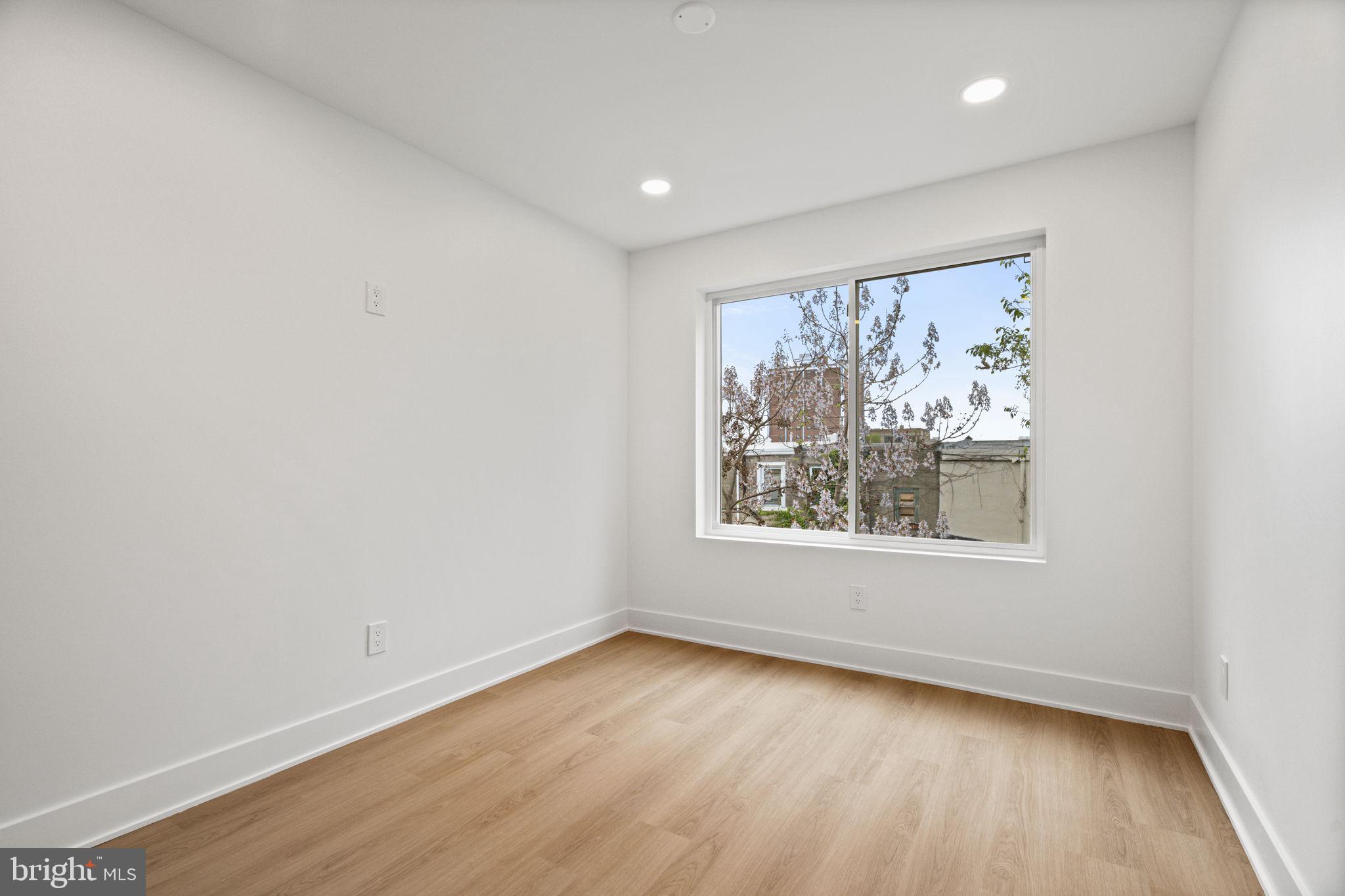 2410 Nicholas Street Philadelphia, PA 19121 - Photo 24 of 55 an empty room with wooden floor and windows