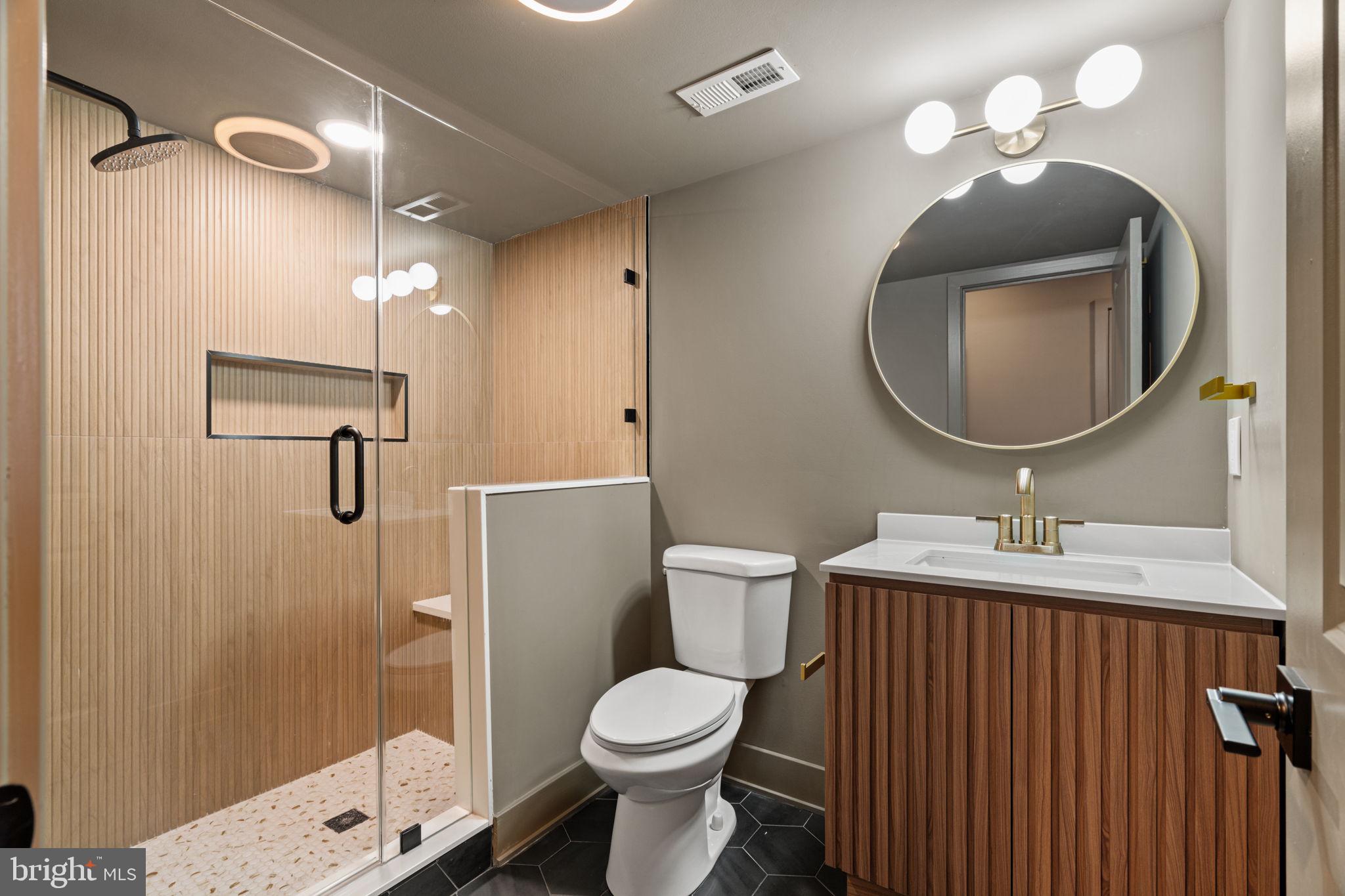 2410 Nicholas Street Philadelphia, PA 19121 - Photo 26 of 55 a bathroom with a toilet sink vanity and mirror